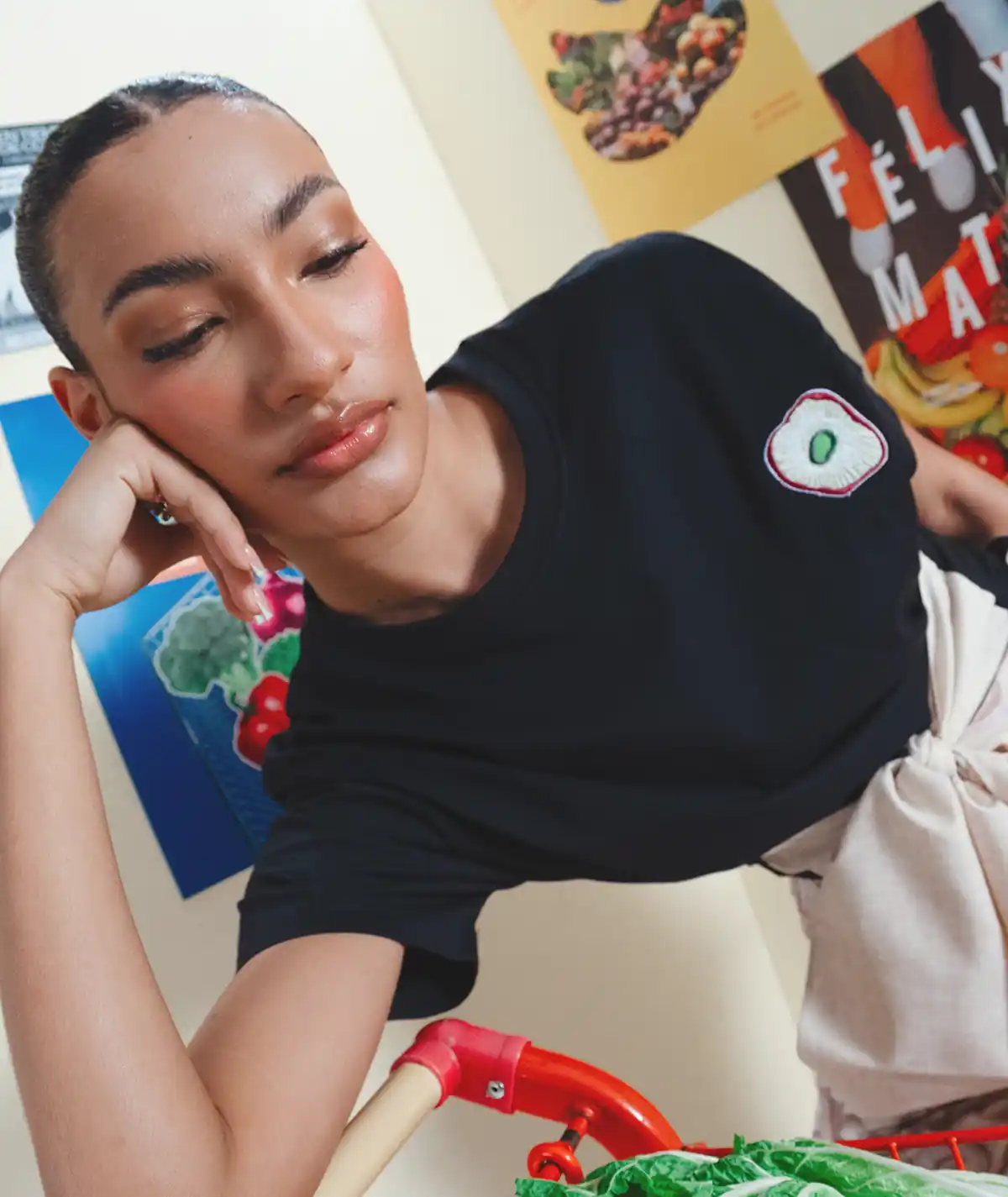 Ajo T-Shirt – Editorial Upper Body Detail View Editorial upper body detail view of the Felix Matos Ajo T-Shirt featuring a black short-sleeve silhouette with embroidered chest appliqué.