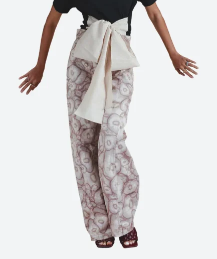 Product detail front view of the Felix Matos Allium Pants featuring a salmon and white organic print with wide-leg silhouette and front bow detail.