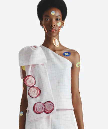 Product detail view of the Felix Matos Huerto Top featuring a pale pink asymmetric one-shoulder silhouette with circular embroidered appliqués.