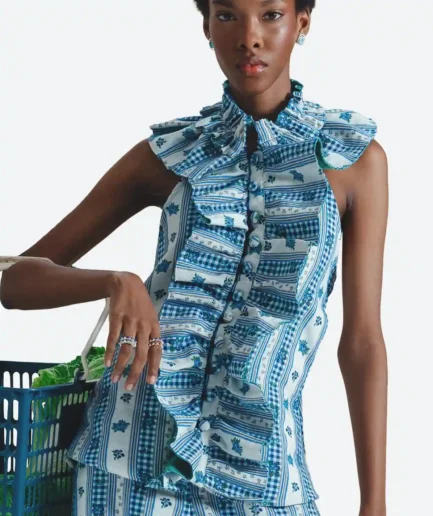 Product detail front view of the Felix Matos Rocío Blouse featuring a blue and white printed sleeveless silhouette with ruffled neckline and button-front closure.