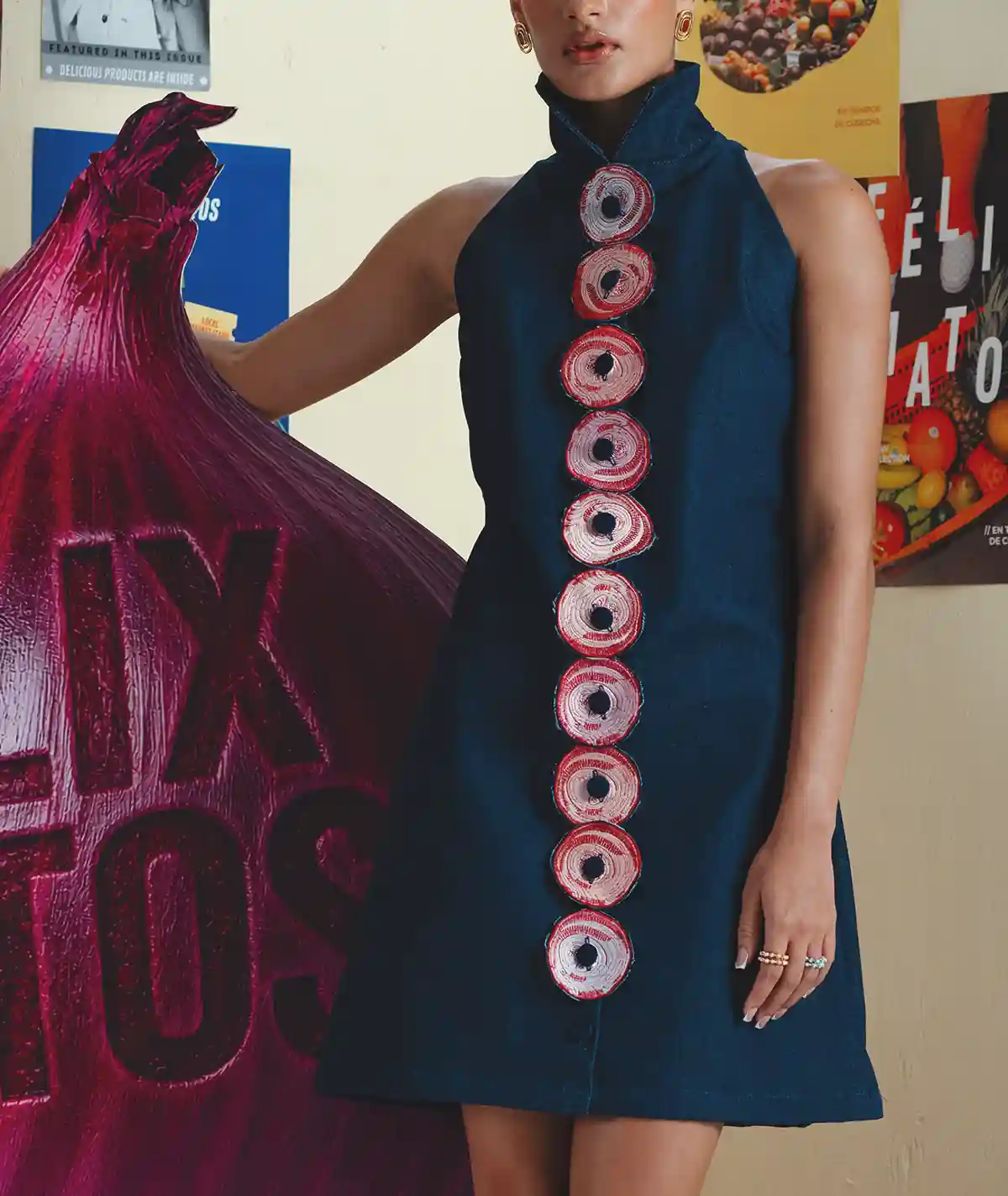 Shallot Dress – Editorial Detail View Editorial detail view of the Felix Matos Shallot Dress showing the navy fabric, high neckline and circular embroidered appliqué details.