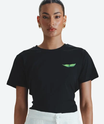 Product detail view of the Felix Matos Soya T-Shirt featuring a black short-sleeve top with a small green edamame-inspired embroidered detail.