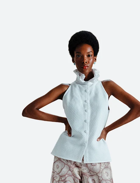 Blouses category product look view for Felix Matos featuring a white sleeveless blouse with a high ruffled collar and button-front closure.