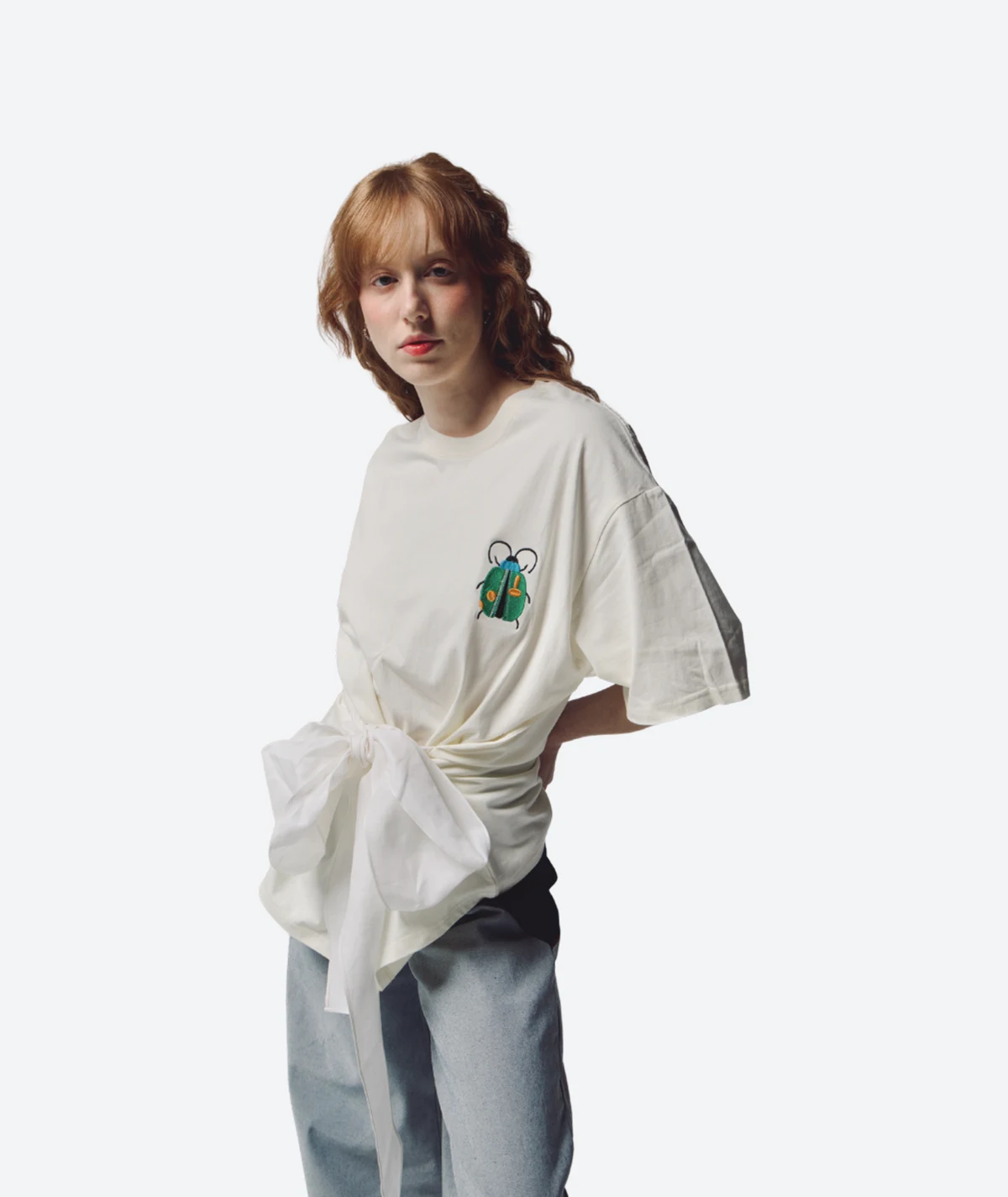 Commune White Bug T-Shirt – Product Look View Product look view from the Felix Matos Commune Collection featuring a white T-shirt with embroidered bug detail and front tie styling.