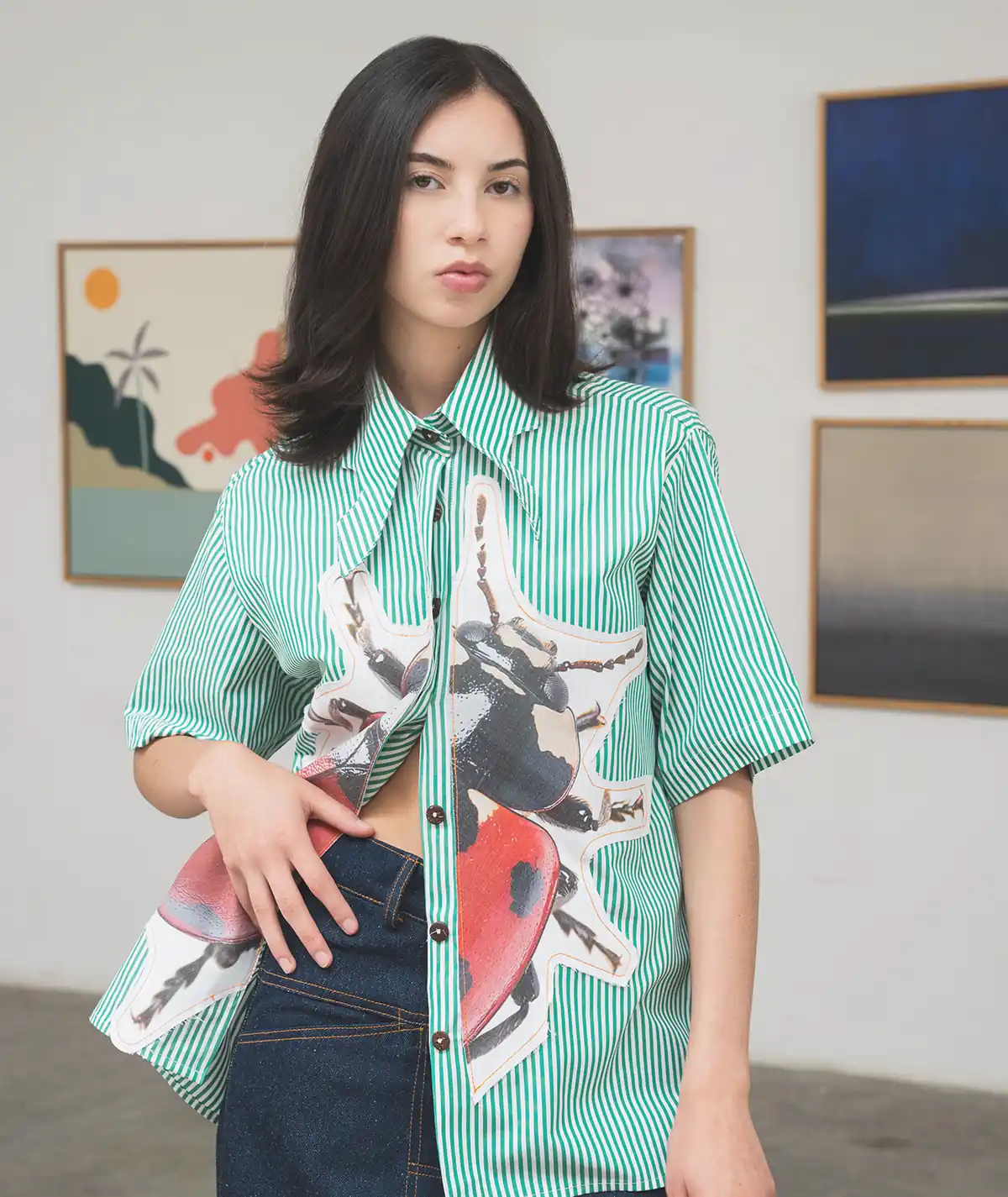 Commune Collection – Catalog Feature Look Catalog feature image for the Felix Matos Commune Collection showing a green striped shirt with graphic appliqué detail styled with dark denim.