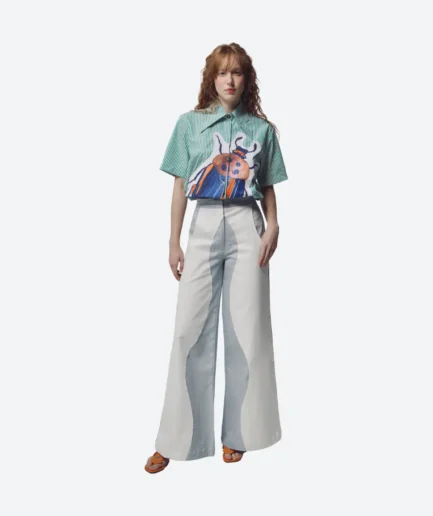Product look front view from the Felix Matos Commune Collection featuring a green striped shirt with a large bug appliqué and light wide-leg pants.